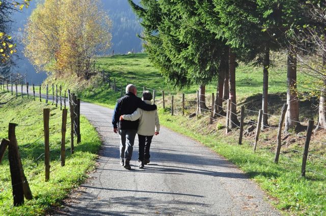 Older couple walking down a country road